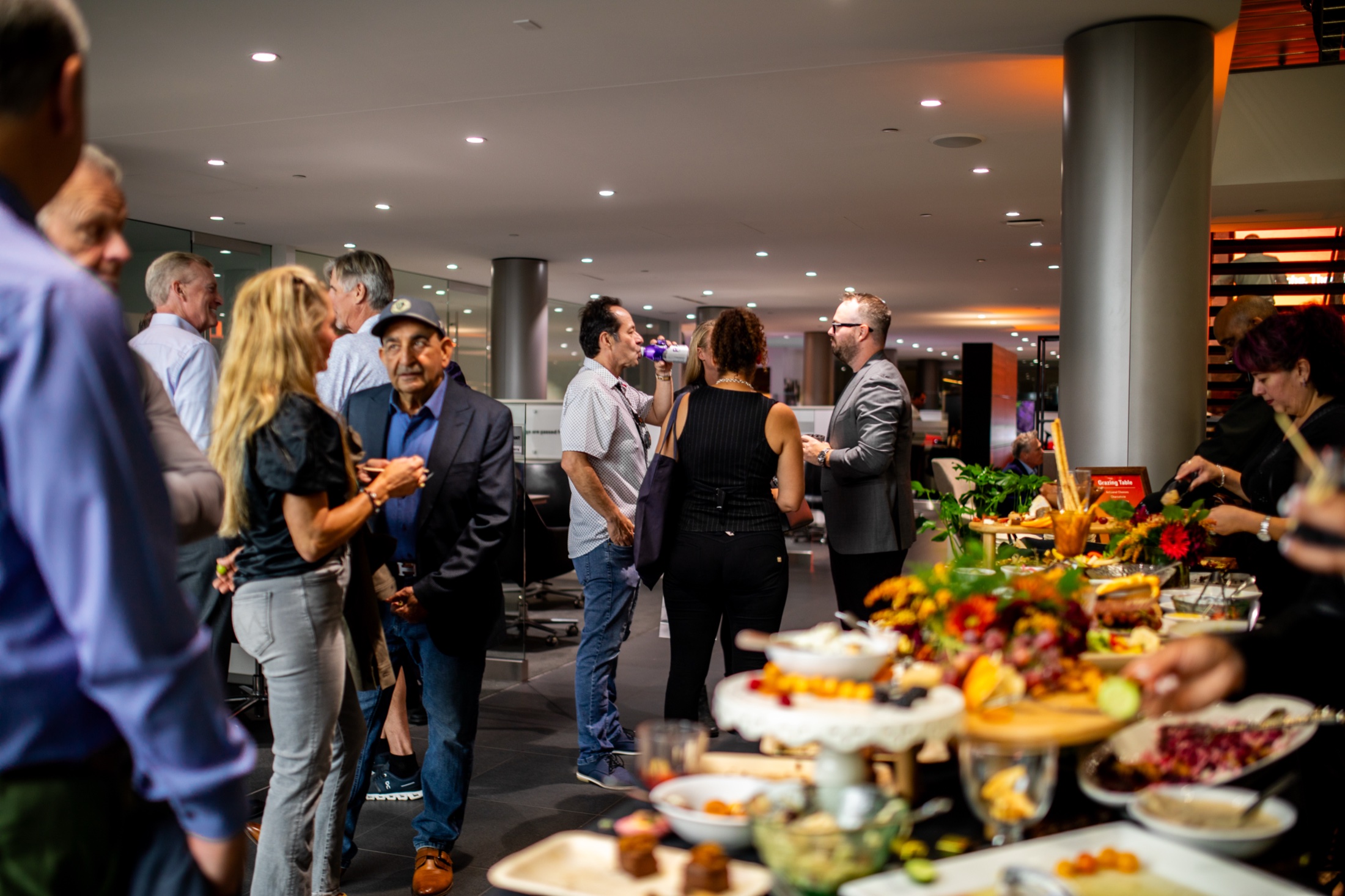 Guests around the catering spread at the 911 Heritage and Horsepower event