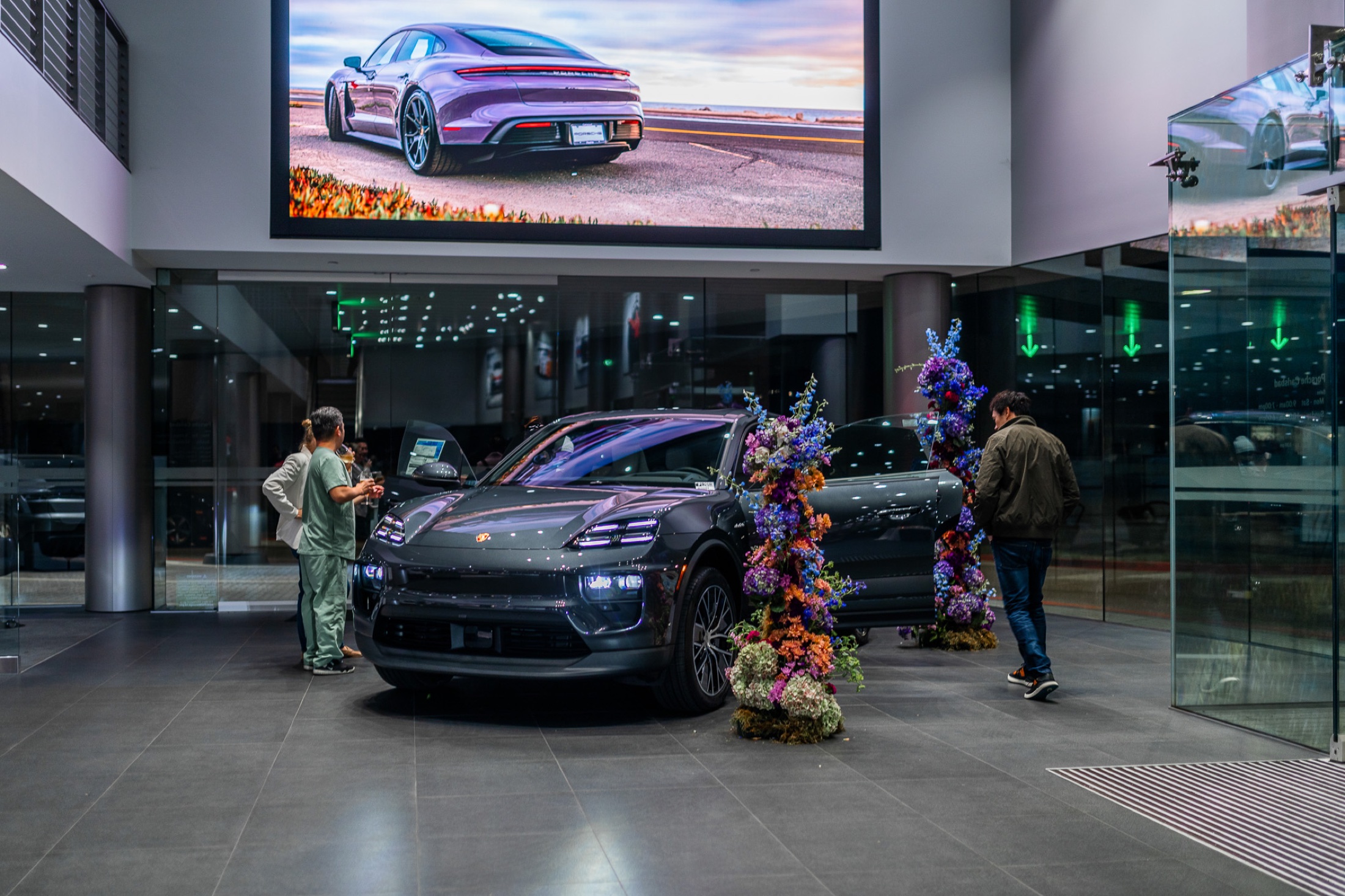 The new Macan EV on display with floral styling at the evening reveal at Porsche Carlsbad