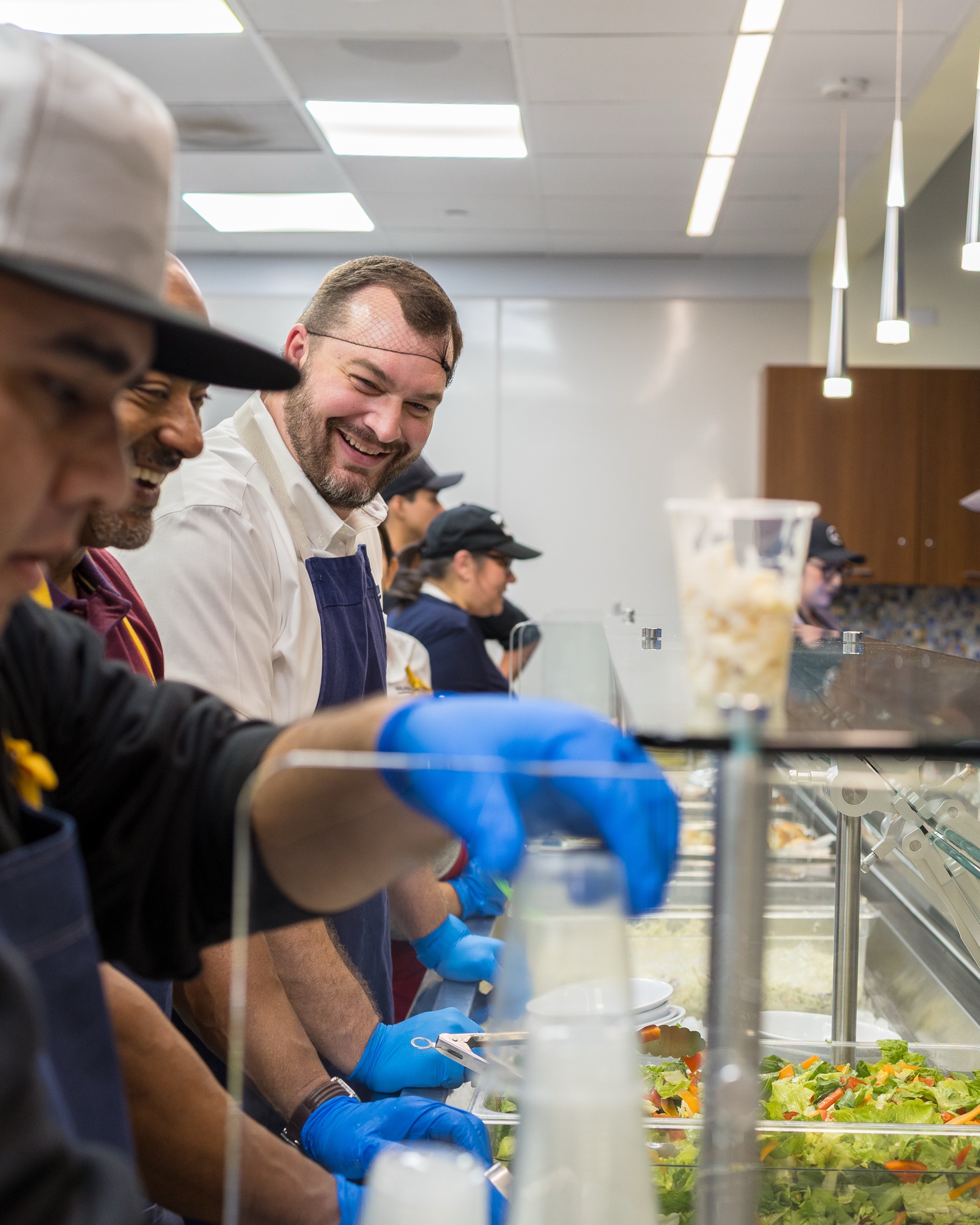Hoehn volunteers serving food in the Ronald McDonald House kitchen